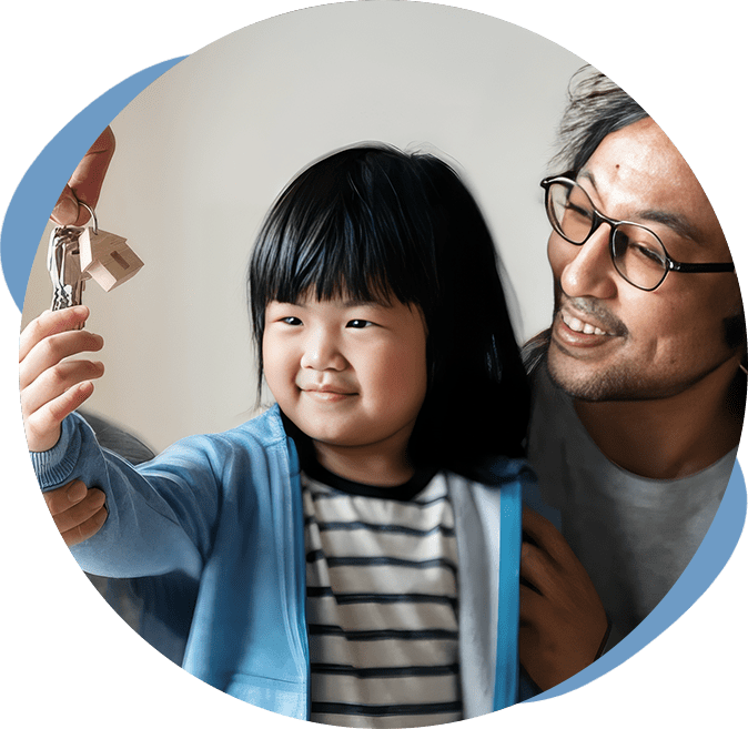A man and child holding up a remote control.