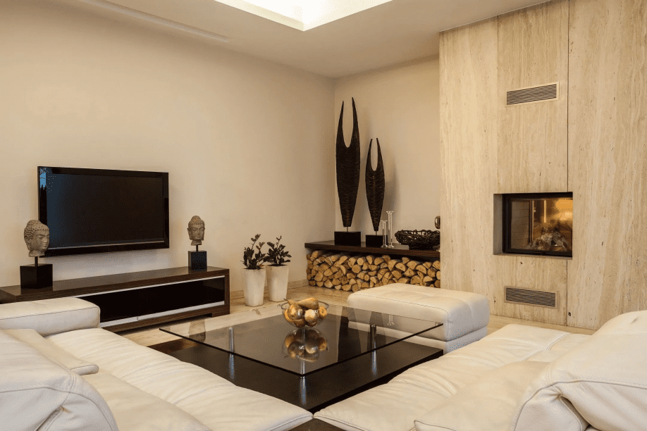 A living room with a fireplace and a flat screen tv.