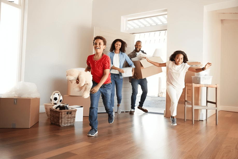 A group of people moving boxes in a room.